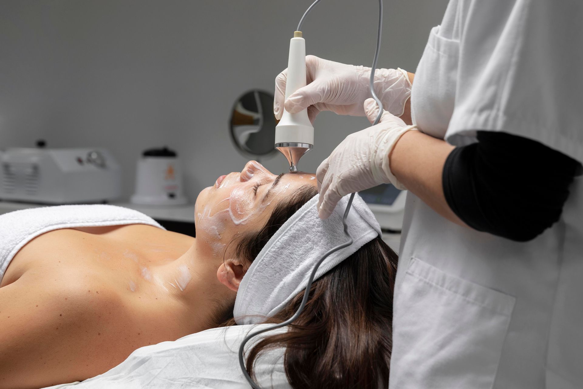 A woman is getting a facial treatment at a spa.