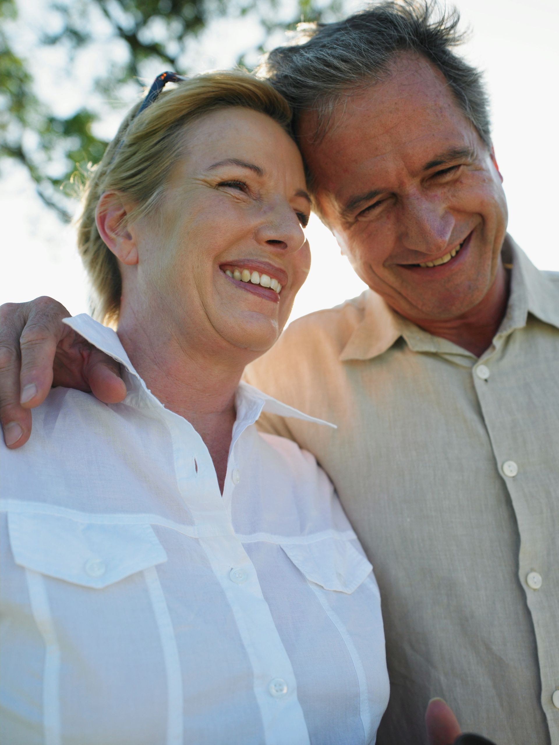 A man and a woman are standing next to each other and smiling.