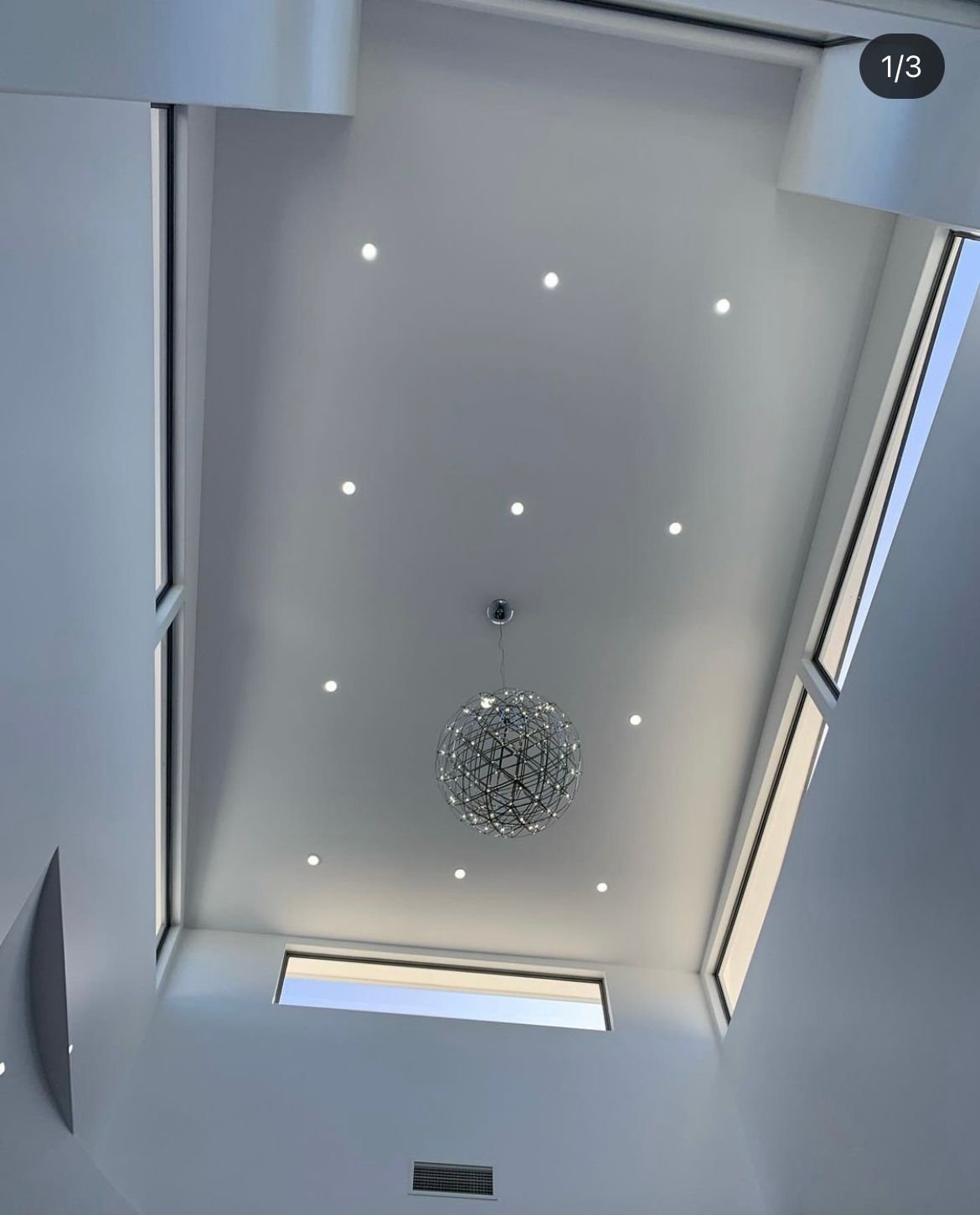 A picture of a ceiling with a chandelier hanging from it.