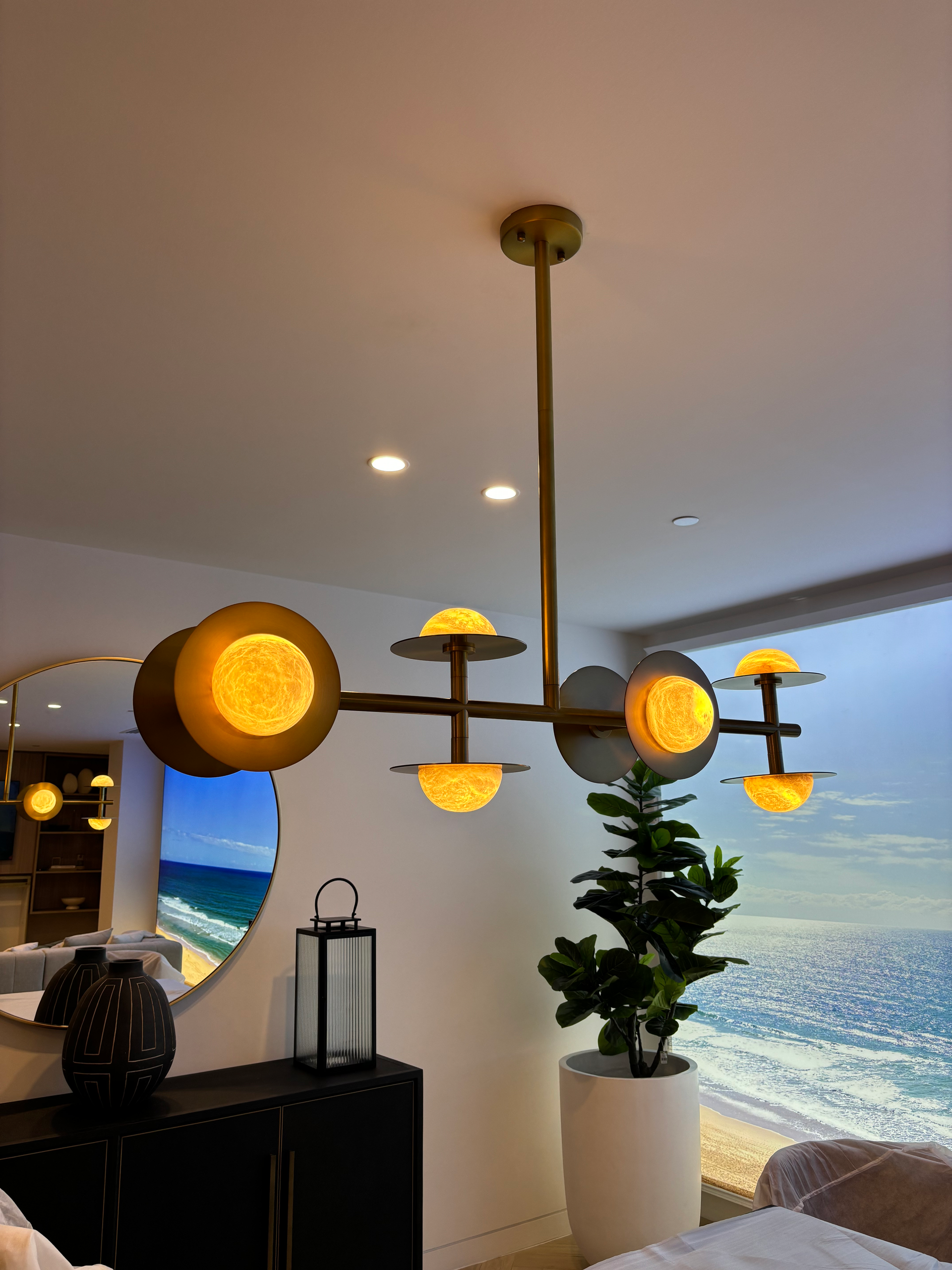 A living room with a chandelier hanging from the ceiling