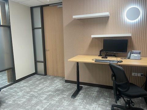 A small office with a desk , chair and computer.