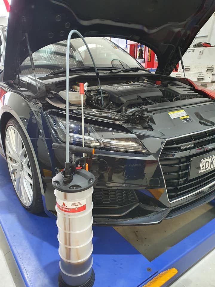 Black Car With Open Hood; Oil Extraction Pump in Front — Motorhead Garage in Tweed Heads, QLD