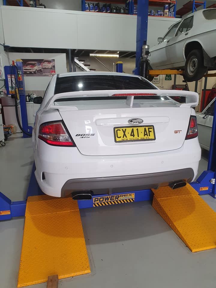 White Ford Falcon St on a Lift in a Workshop — Motorhead Garage in Tweed Heads, QLD
