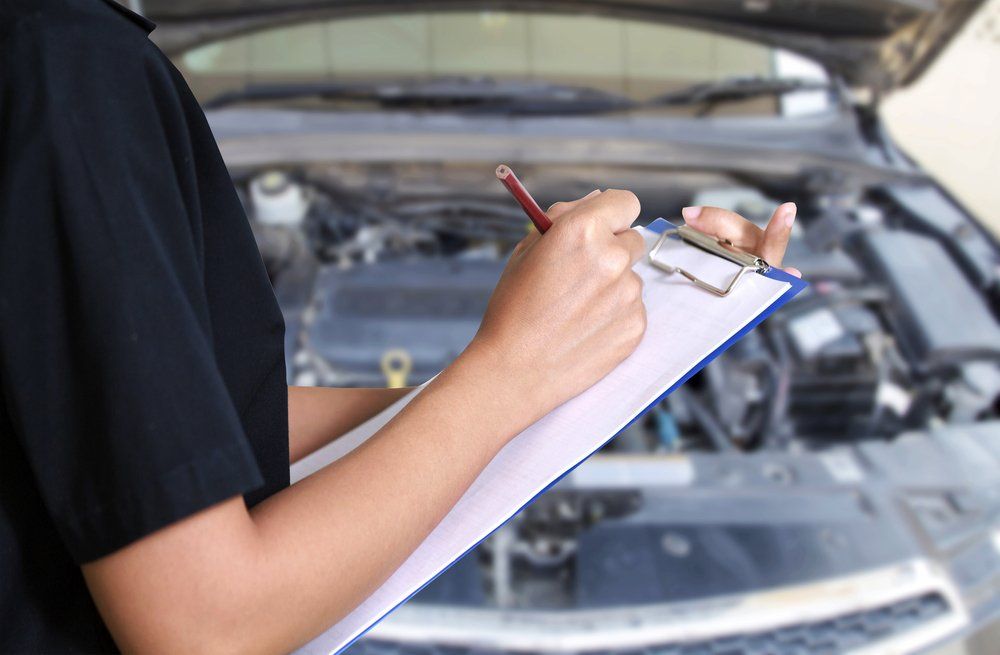 Mechanic Inspecting Car Engine, Writing on Clipboard — Motorhead Garage in Tweed Heads, QLD