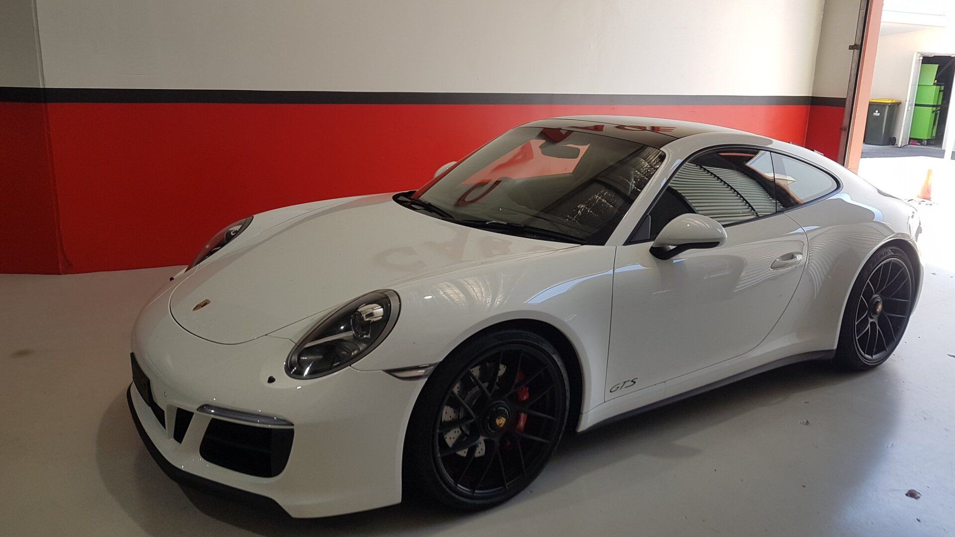 White Porsche Sports Car With Black Wheels in a Garage With Red and Gray Walls — Motorhead Garage in Tweed Heads, QLD