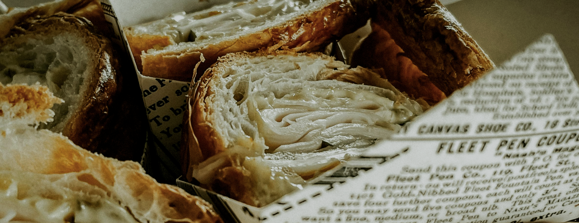 A bunch of bread is sitting on top of a piece of newspaper.