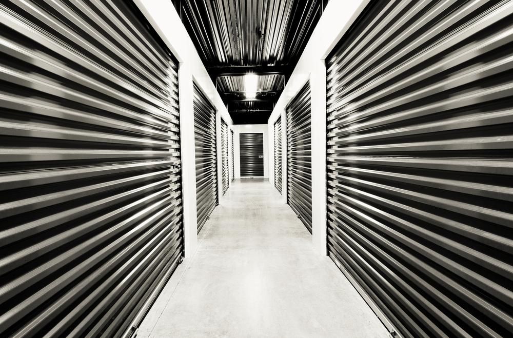 A Black And White Photo Of A Hallway Filled With Rows Of Storage Units — Raymond Terrace Public Storage In Medowie, NSW