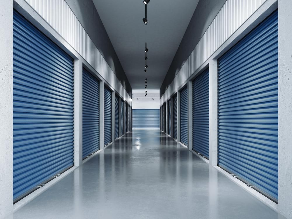 A Long Hallway With Blue Shutters On The Doors — Raymond Terrace Public Storage In Beresfield, NSW