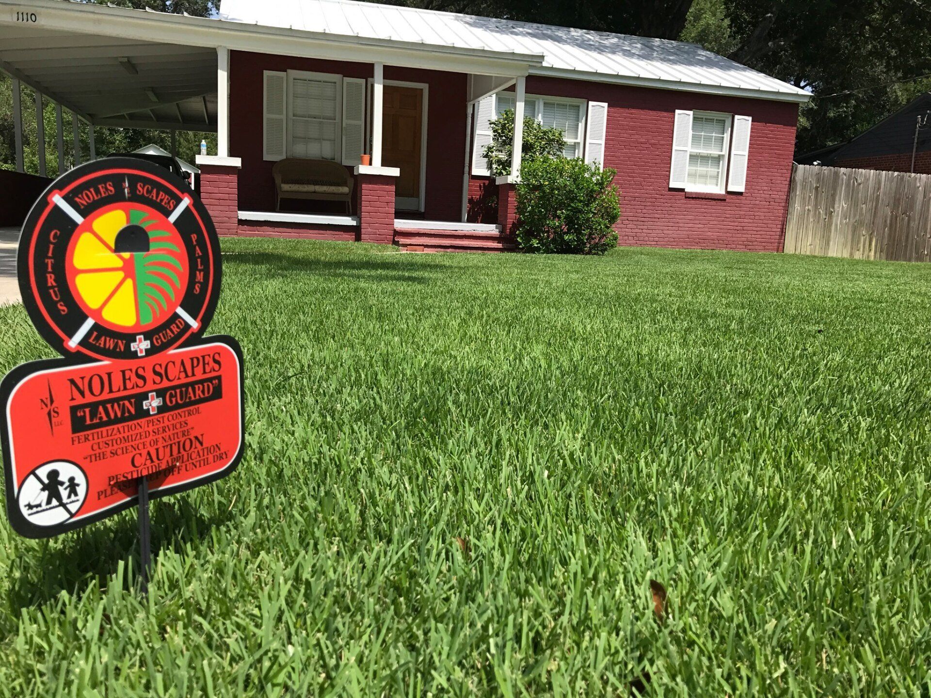 House with Noles Scapes signboard - Panama City, FL - Noles Scapes