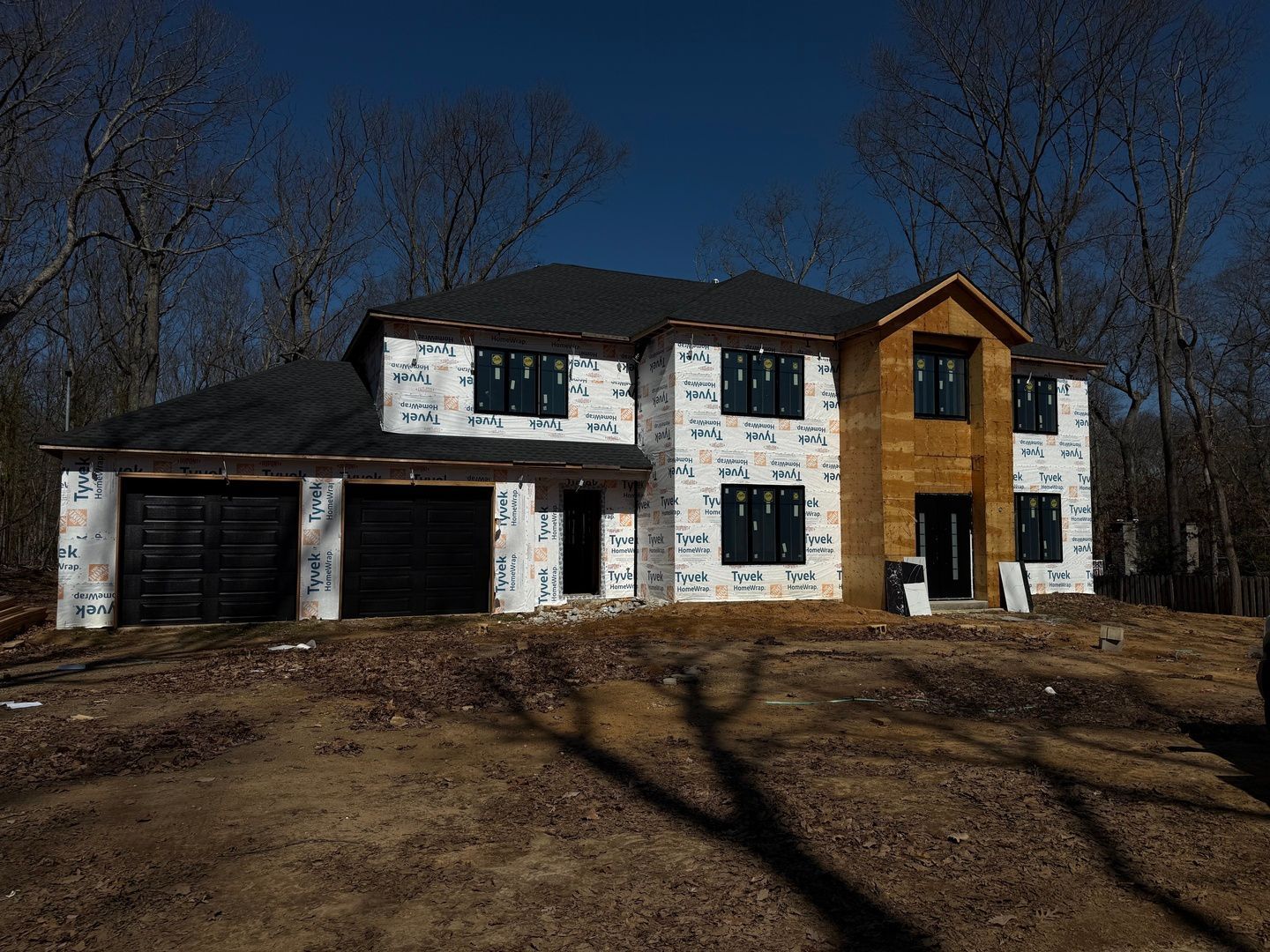A large house is being built in the middle of a forest.