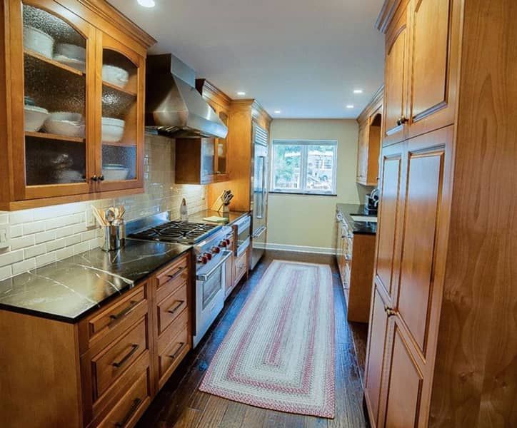 A kitchen with wooden cabinets and stainless steel appliances