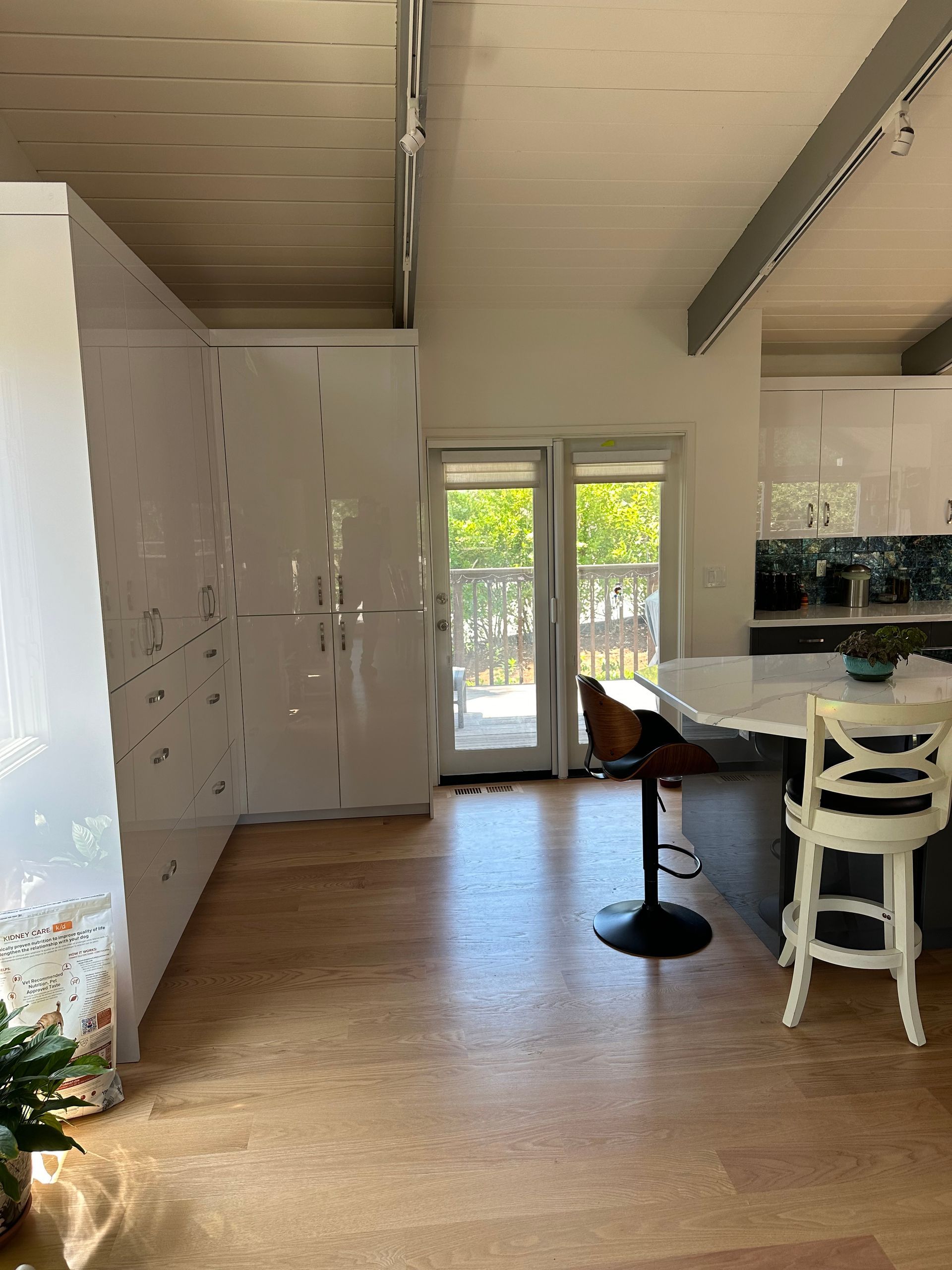 A kitchen with a table and chairs and a sliding glass door.
