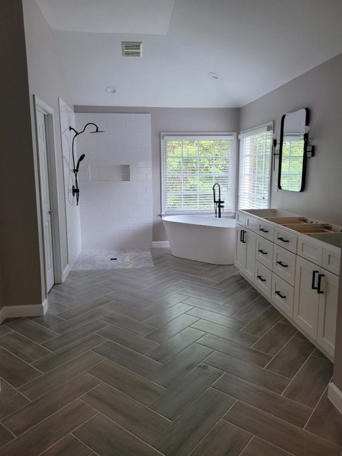 A bathroom with a bathtub , sink , and shower.