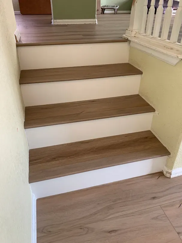 A set of stairs with wooden steps in a house.