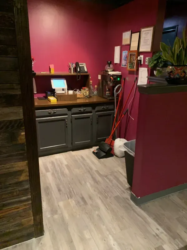 A kitchen with purple walls and a wooden floor