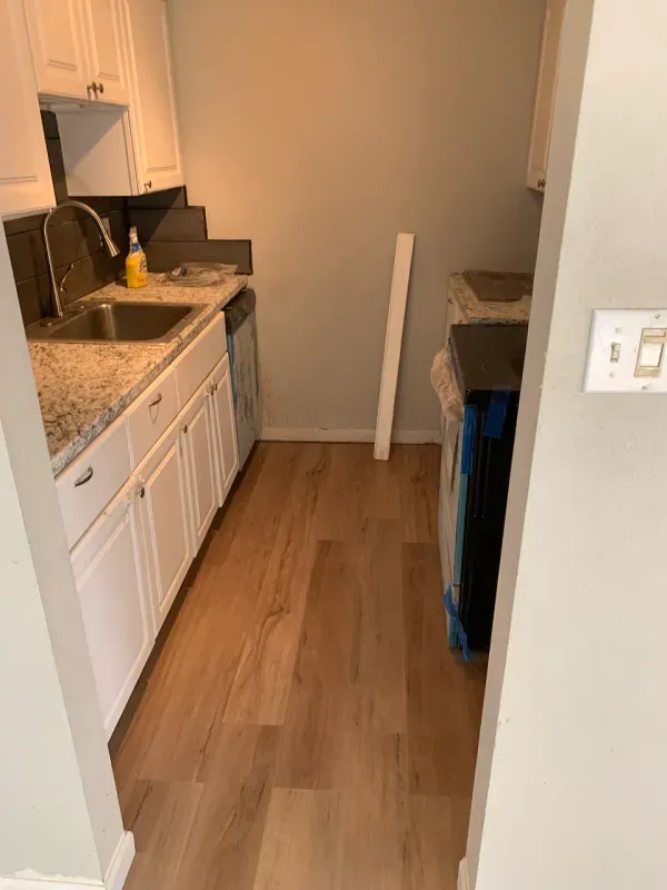 A kitchen with a sink , stove , and dishwasher.