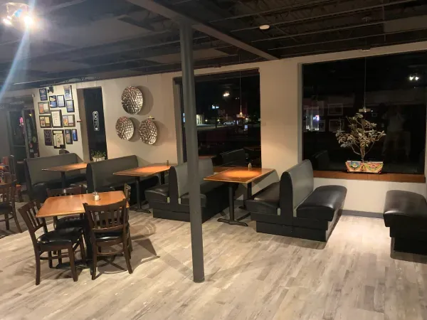 A restaurant with tables and chairs and a window