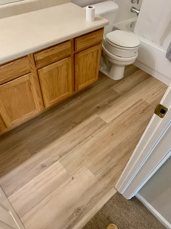 A bathroom with a toilet , sink , and bathtub.