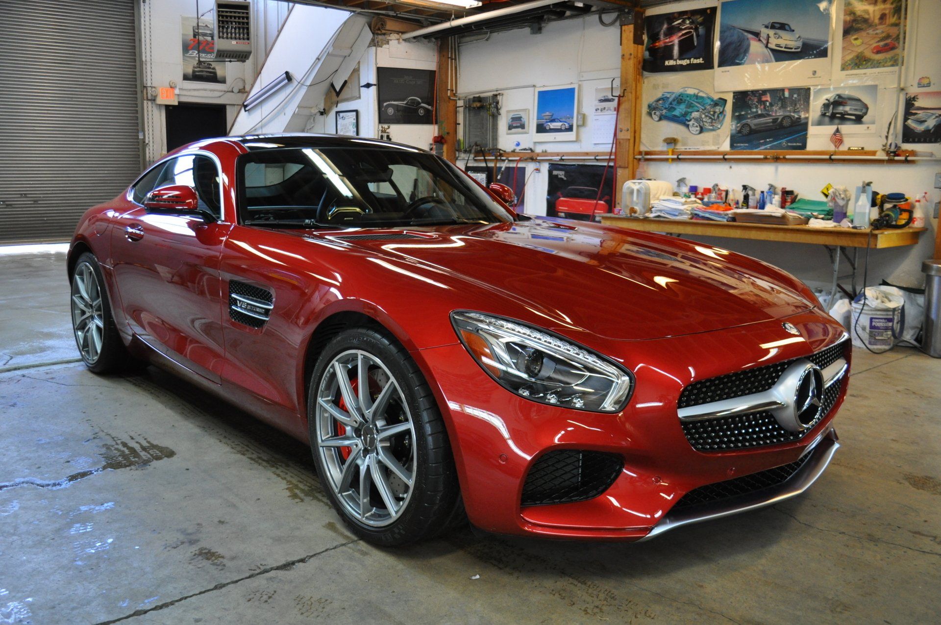 A red mercedes benz gt is parked in a garage