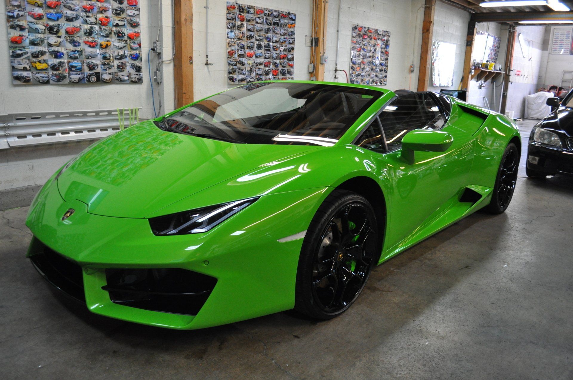 A green lamborghini huracan is parked in a garage