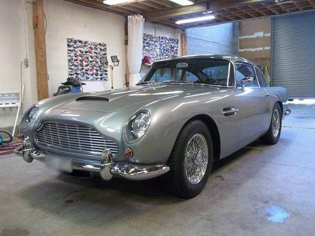 A silver car is parked in a garage.
