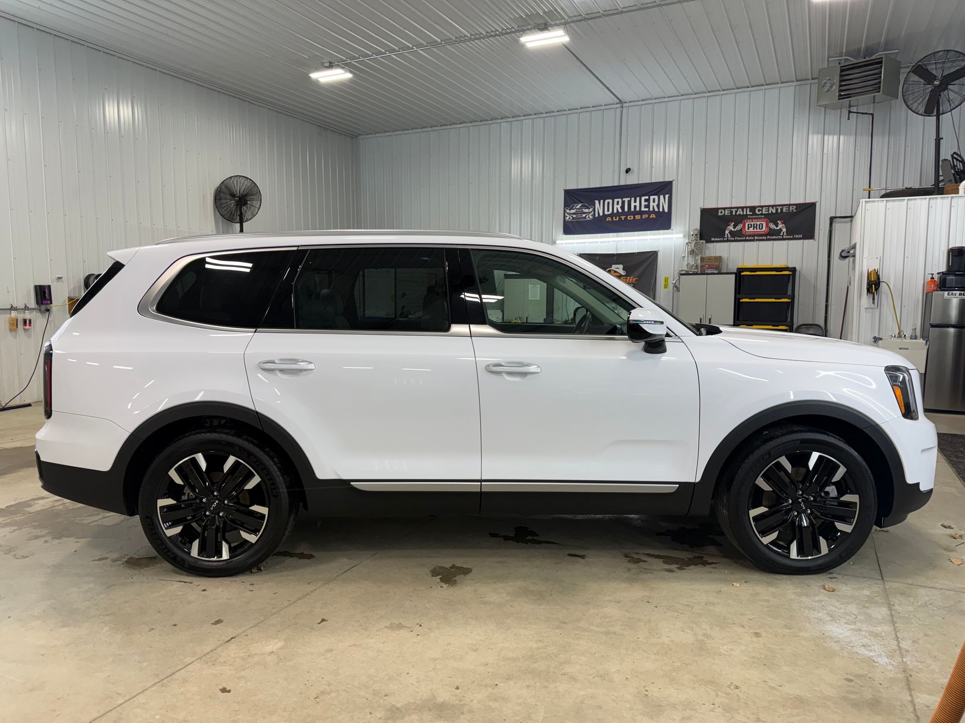 A sleek black Chevrolet Camaro parked on asphalt with a blurred background.