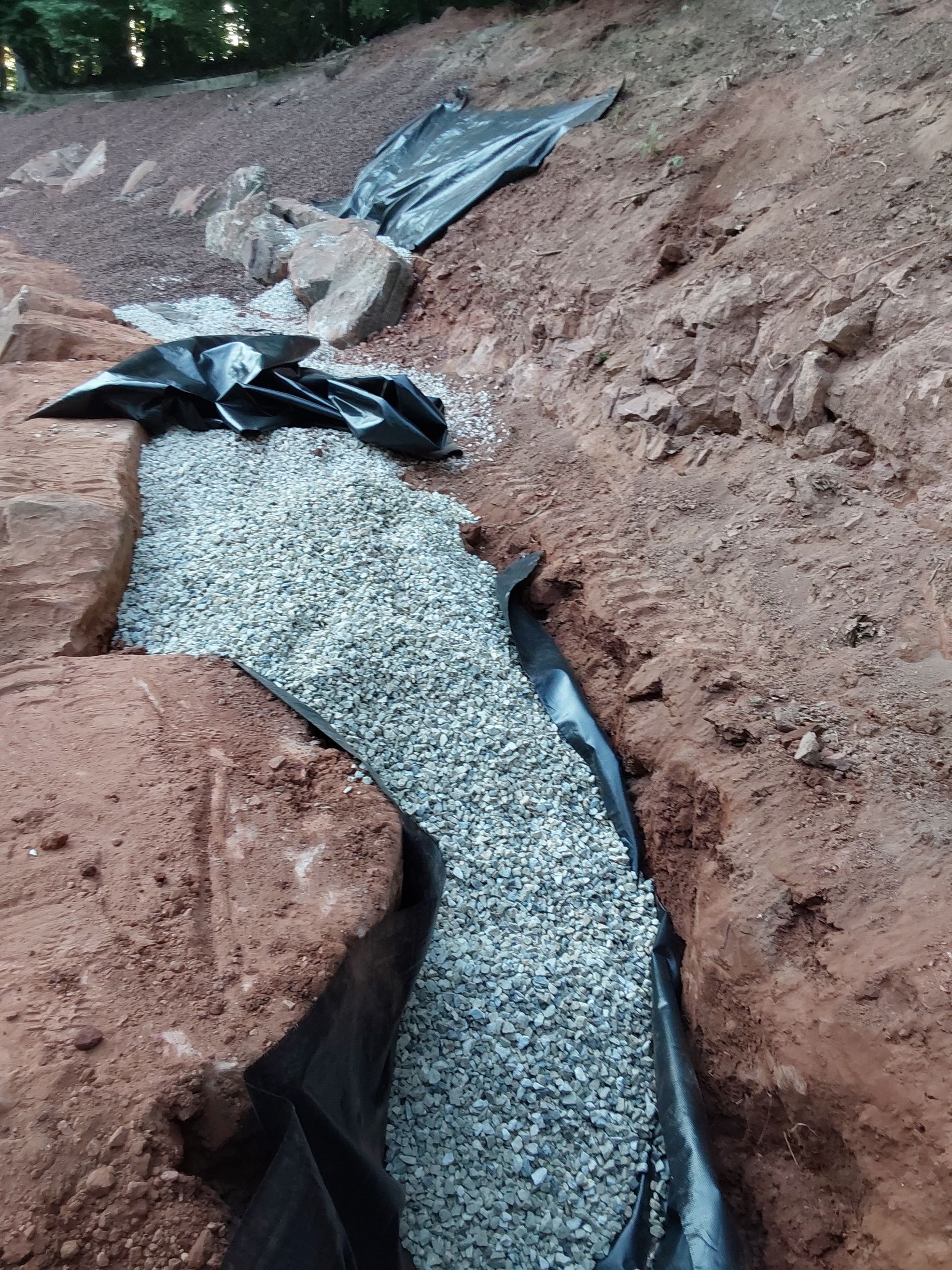 a pile of gravel is sitting on top of a dirt hill