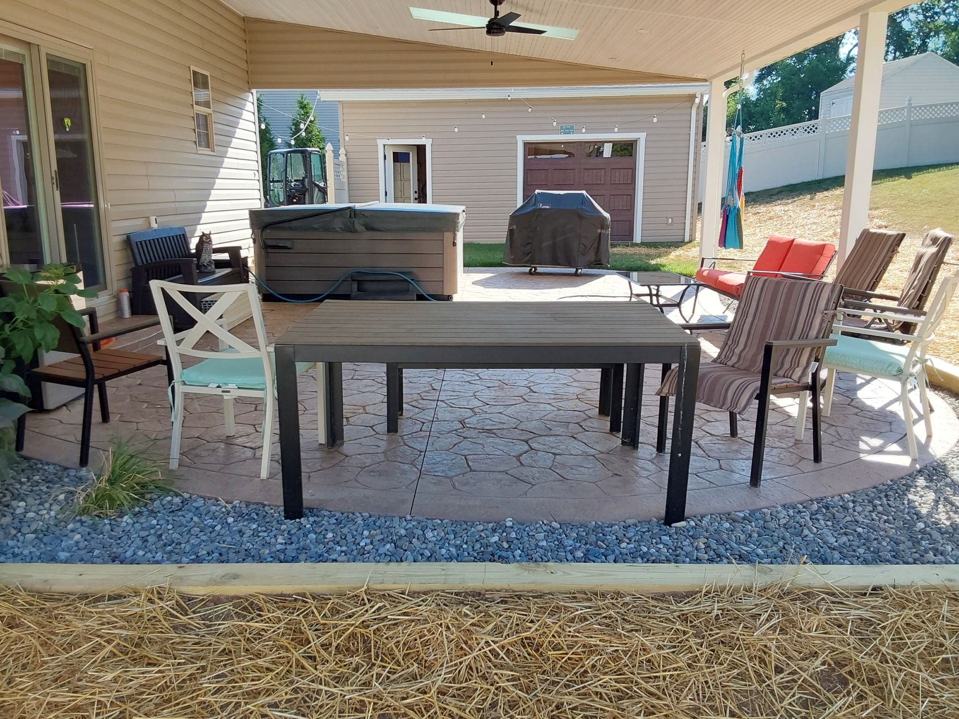 a patio with a table and chairs and a hot tub