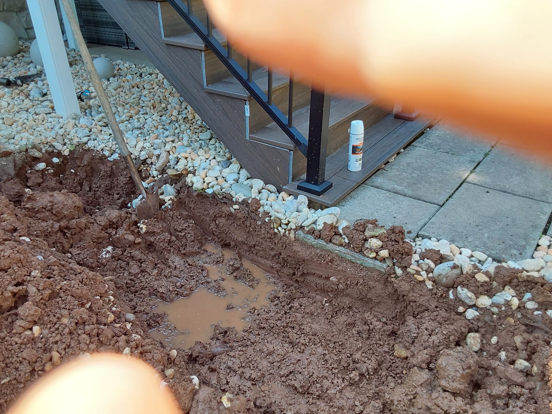 a person is digging a hole in the ground next to stairs
