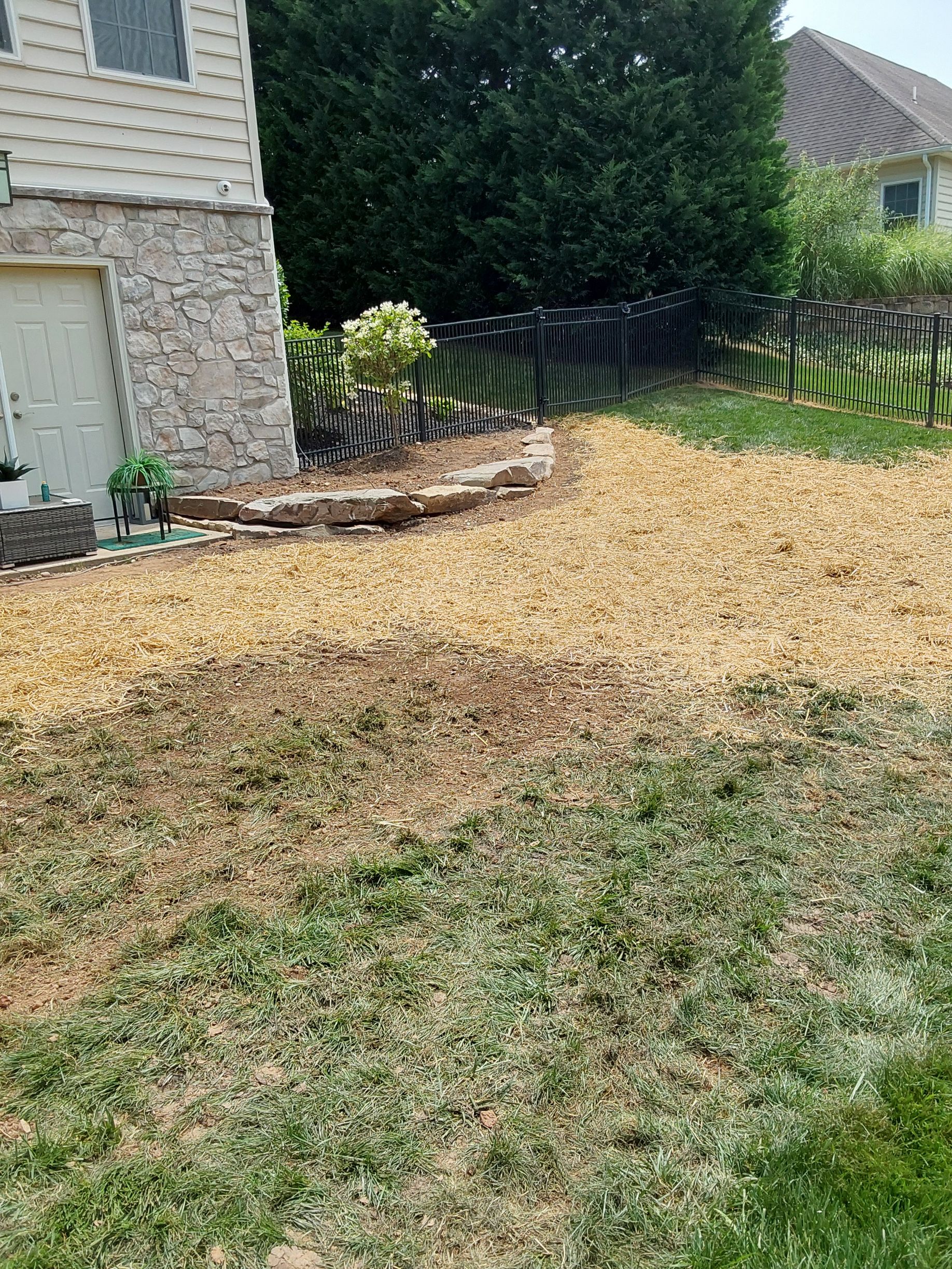 a large pile of mulch is sitting in front of a house