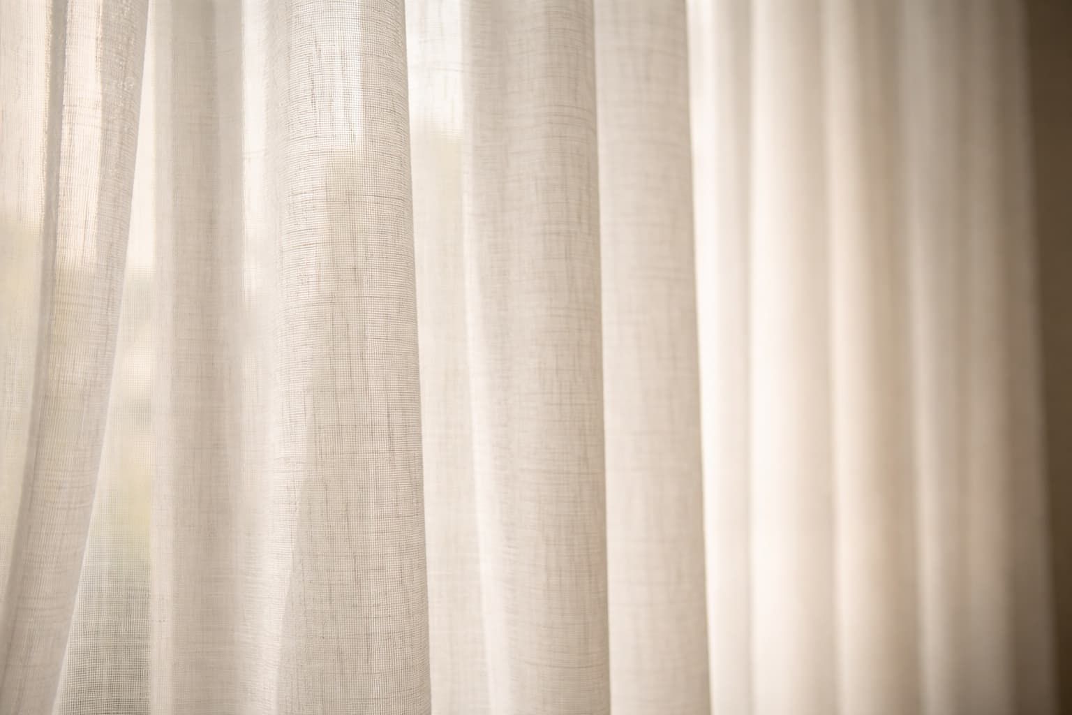 Close-up of sheer curtain fabric with natural light