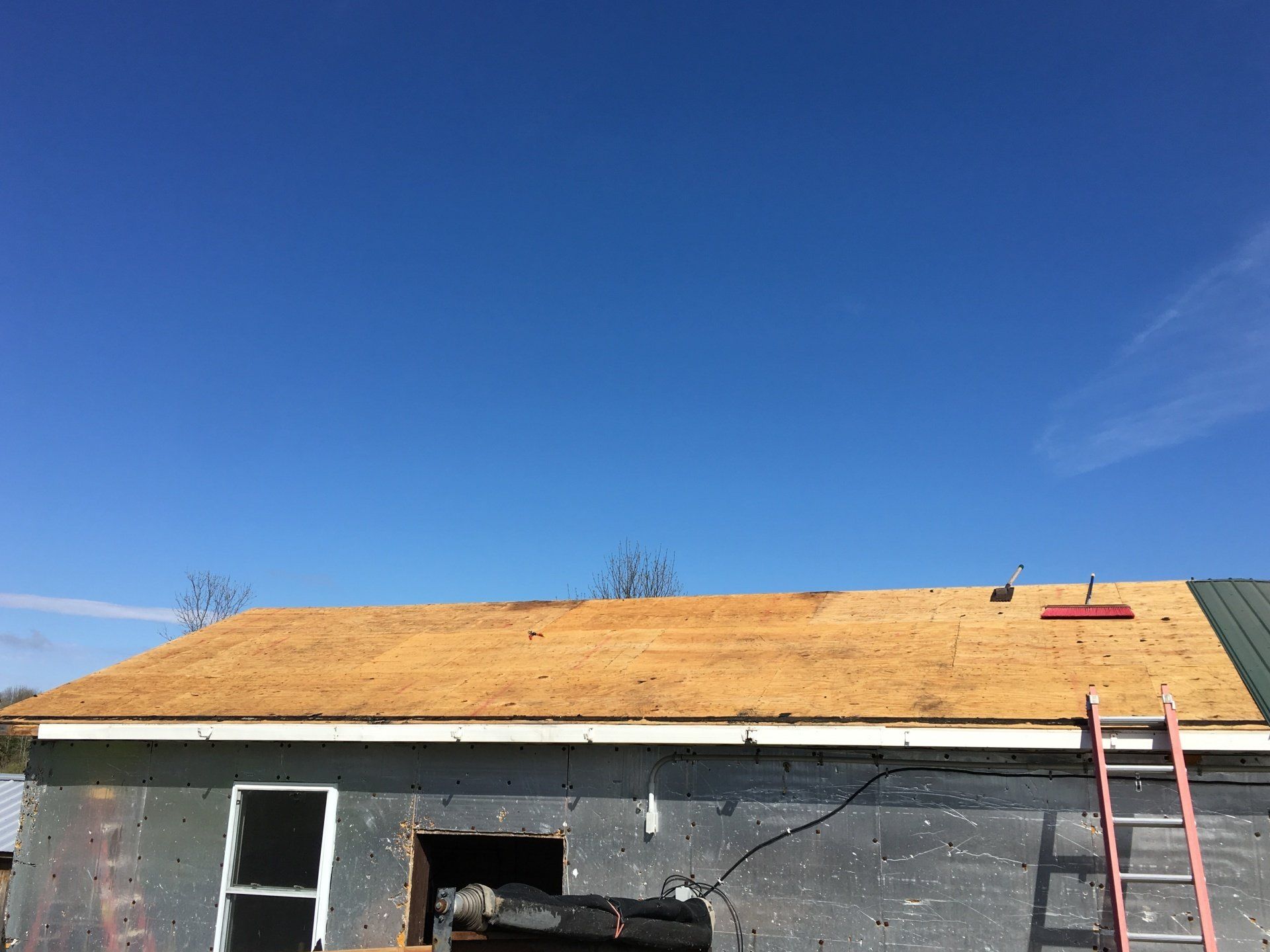 A ladder is sitting on the side of a building under construction.