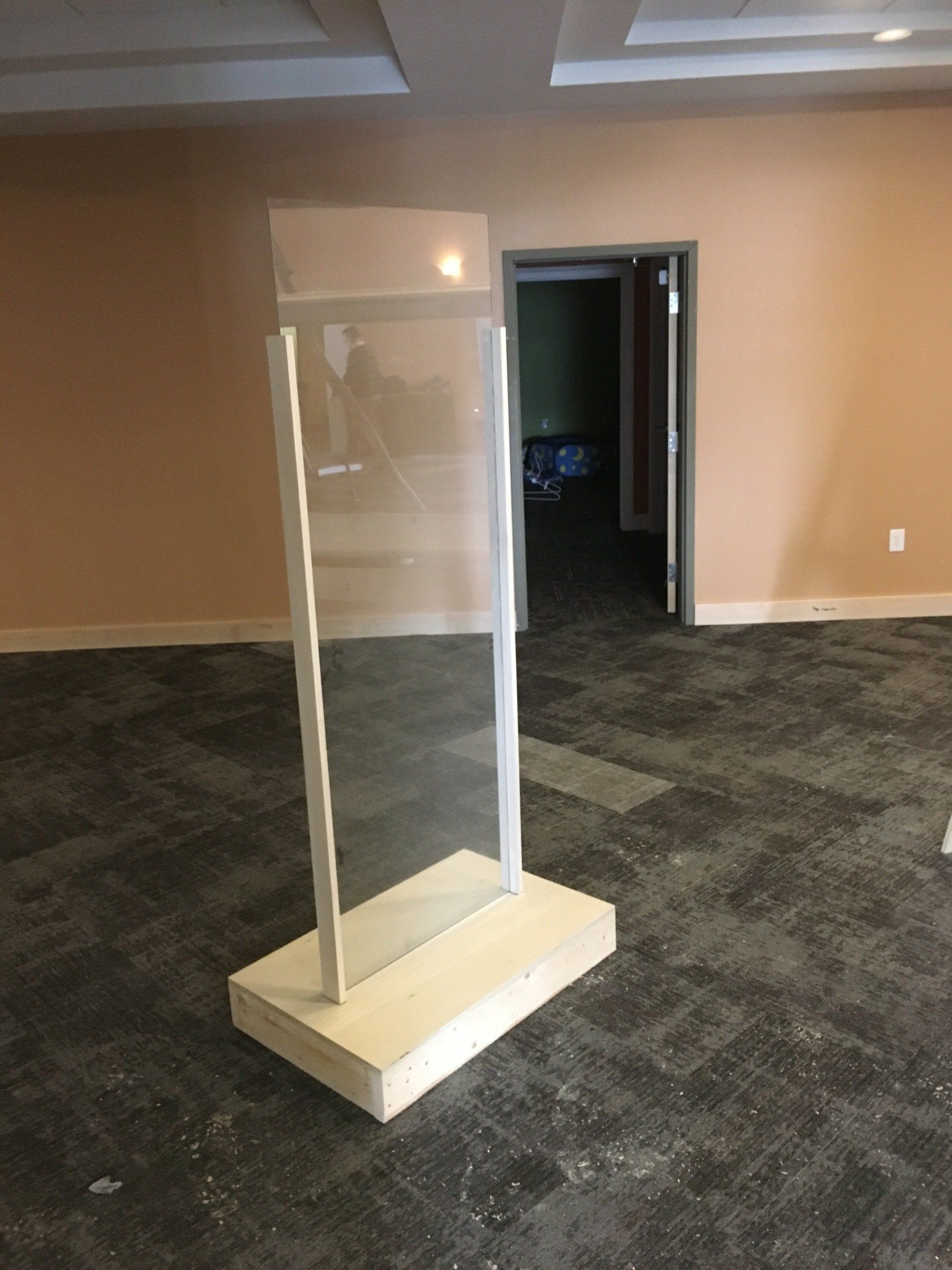 An empty room with a clear glass divider in the middle