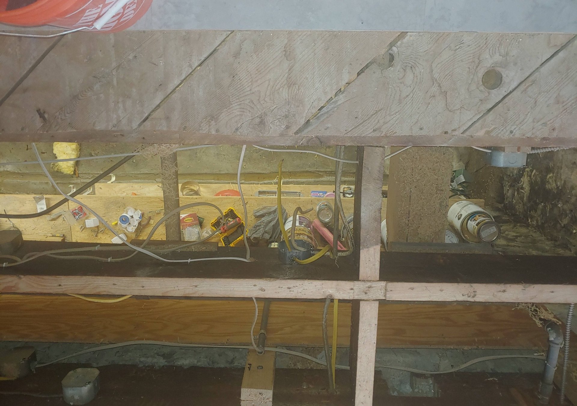 A bunch of wires are hanging from the ceiling of a building.