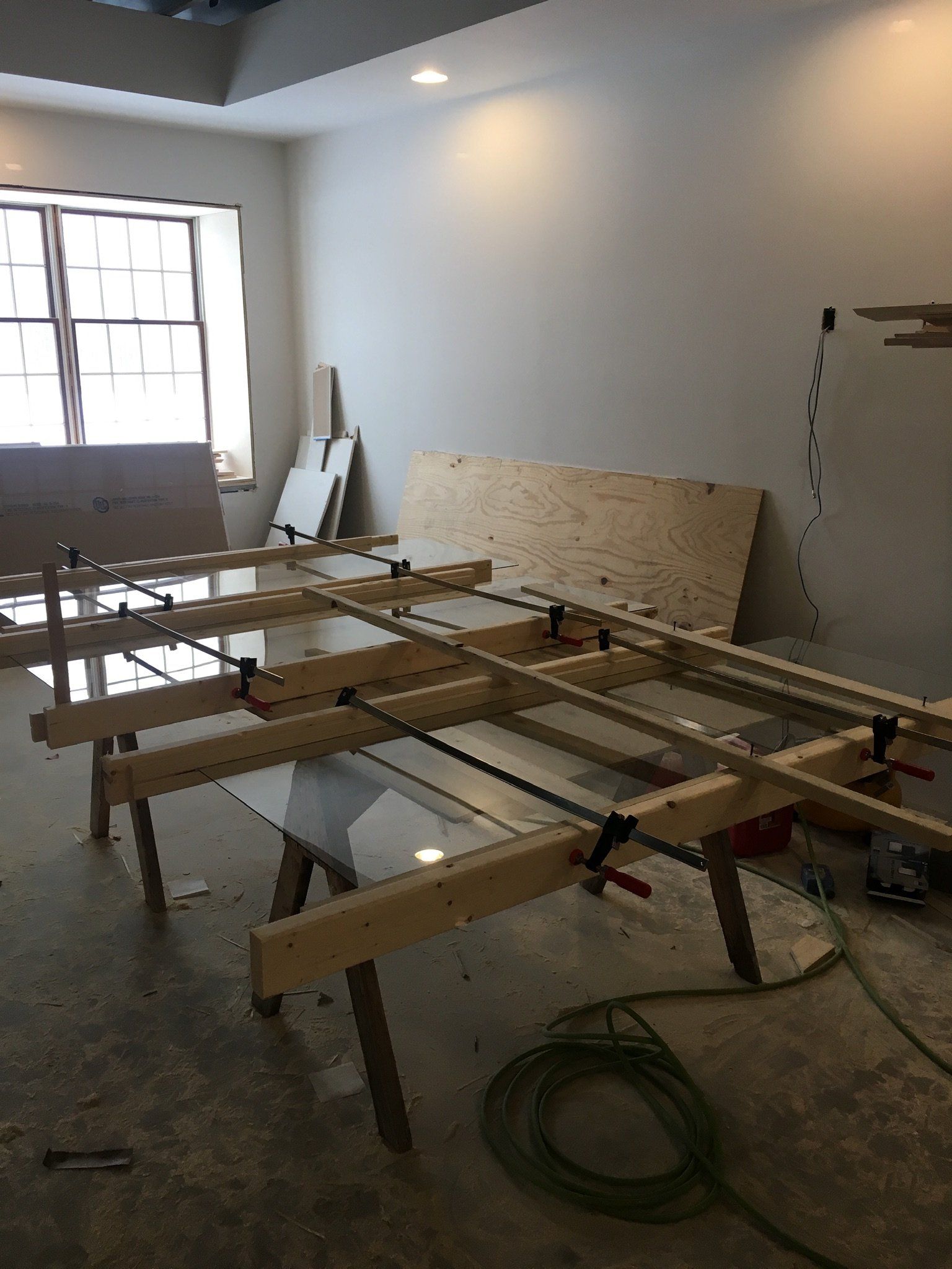 A room with a lot of wooden pieces on the floor