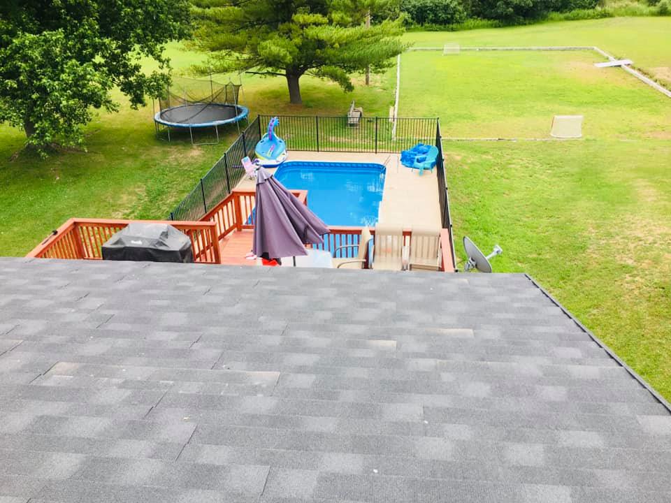 A view of a swimming pool from the roof of a house.