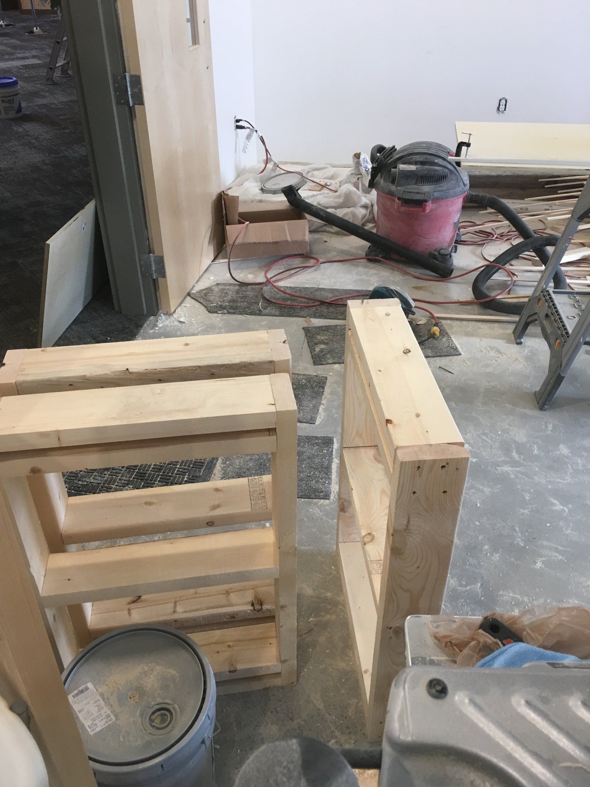 A vacuum cleaner is sitting on the floor next to a wooden box.