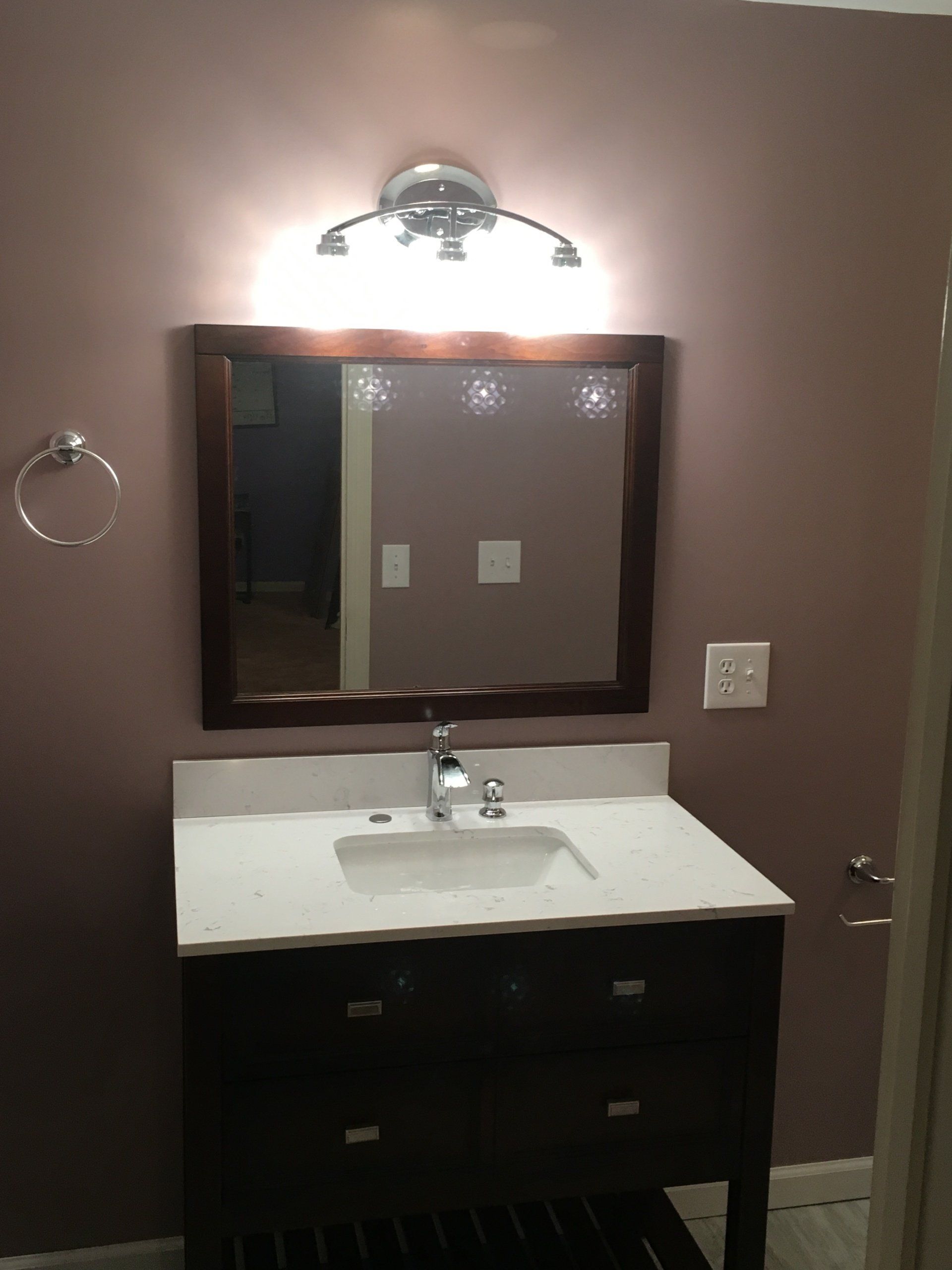 A bathroom sink with a mirror above it