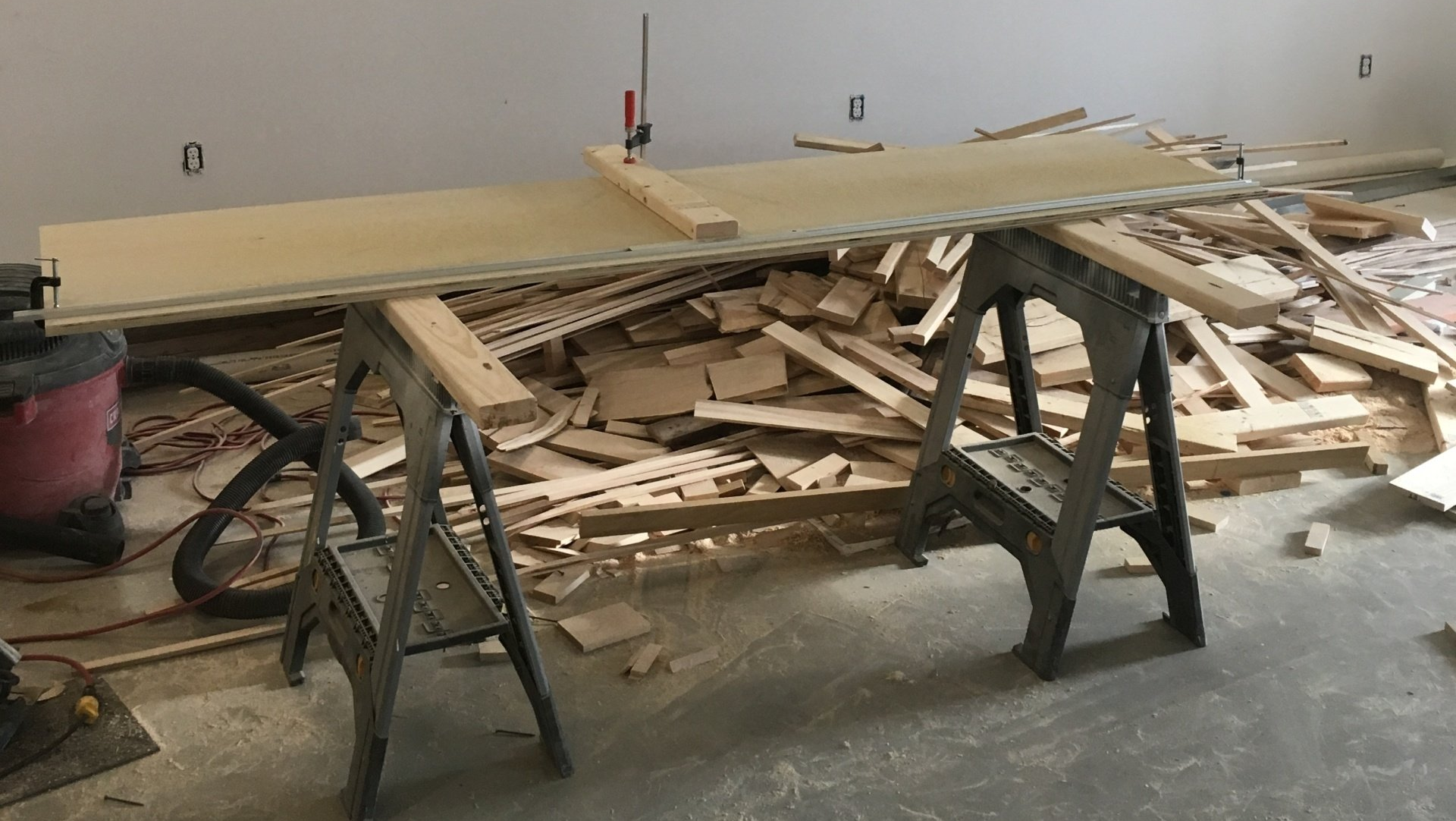 A bunch of wood is laying on the floor in a room