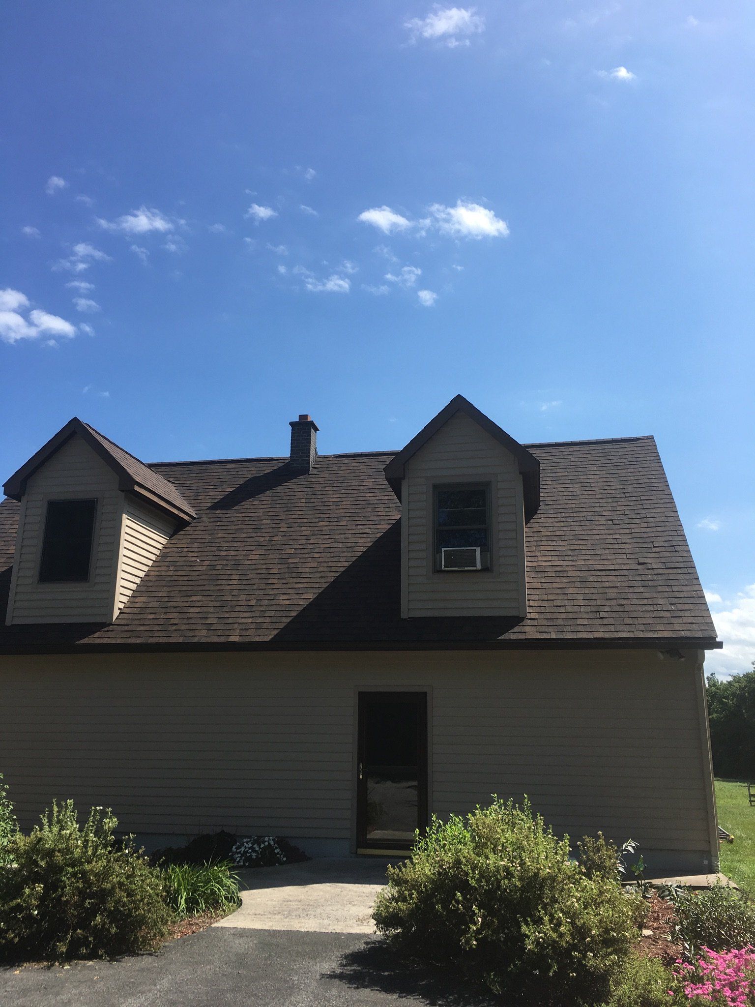 A house with a roof that has shingles on it