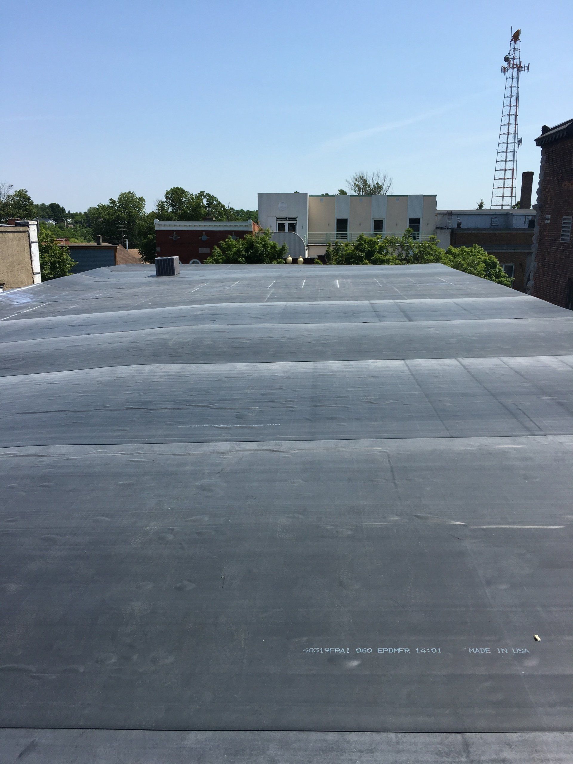 A roof with a few buildings in the background