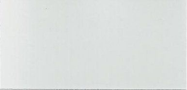 A close up of a white tile on a wall.