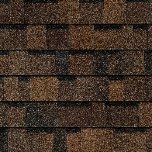 A close up of a roof with brown and black shingles.