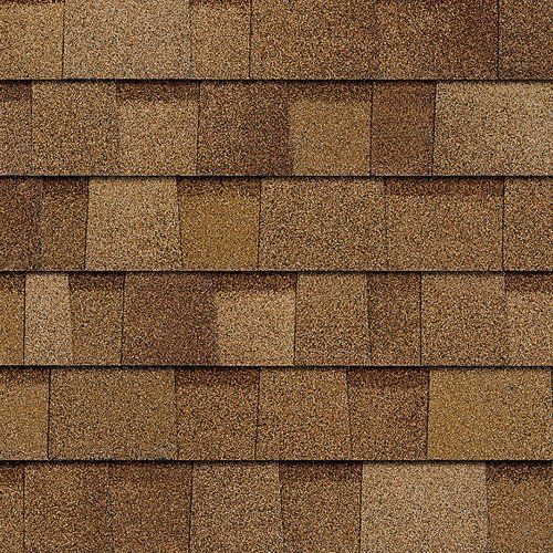 A close up of a row of brown shingles on a roof.