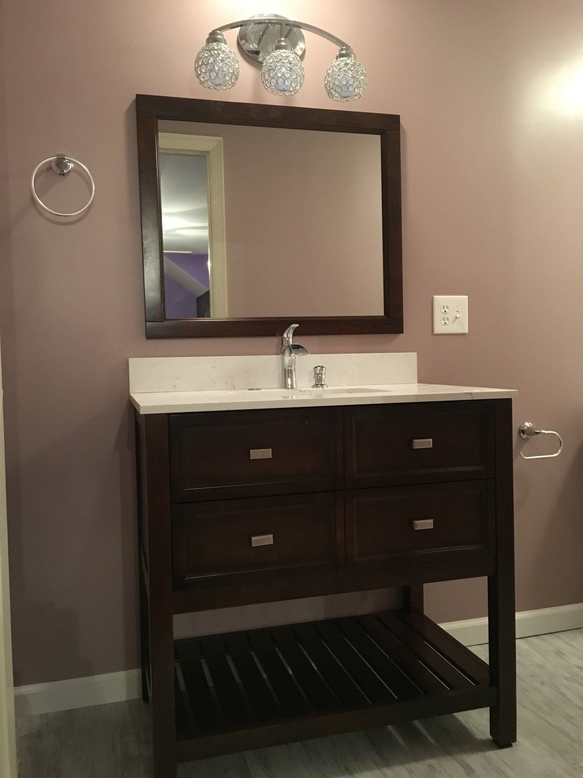 A bathroom with a vanity and a mirror