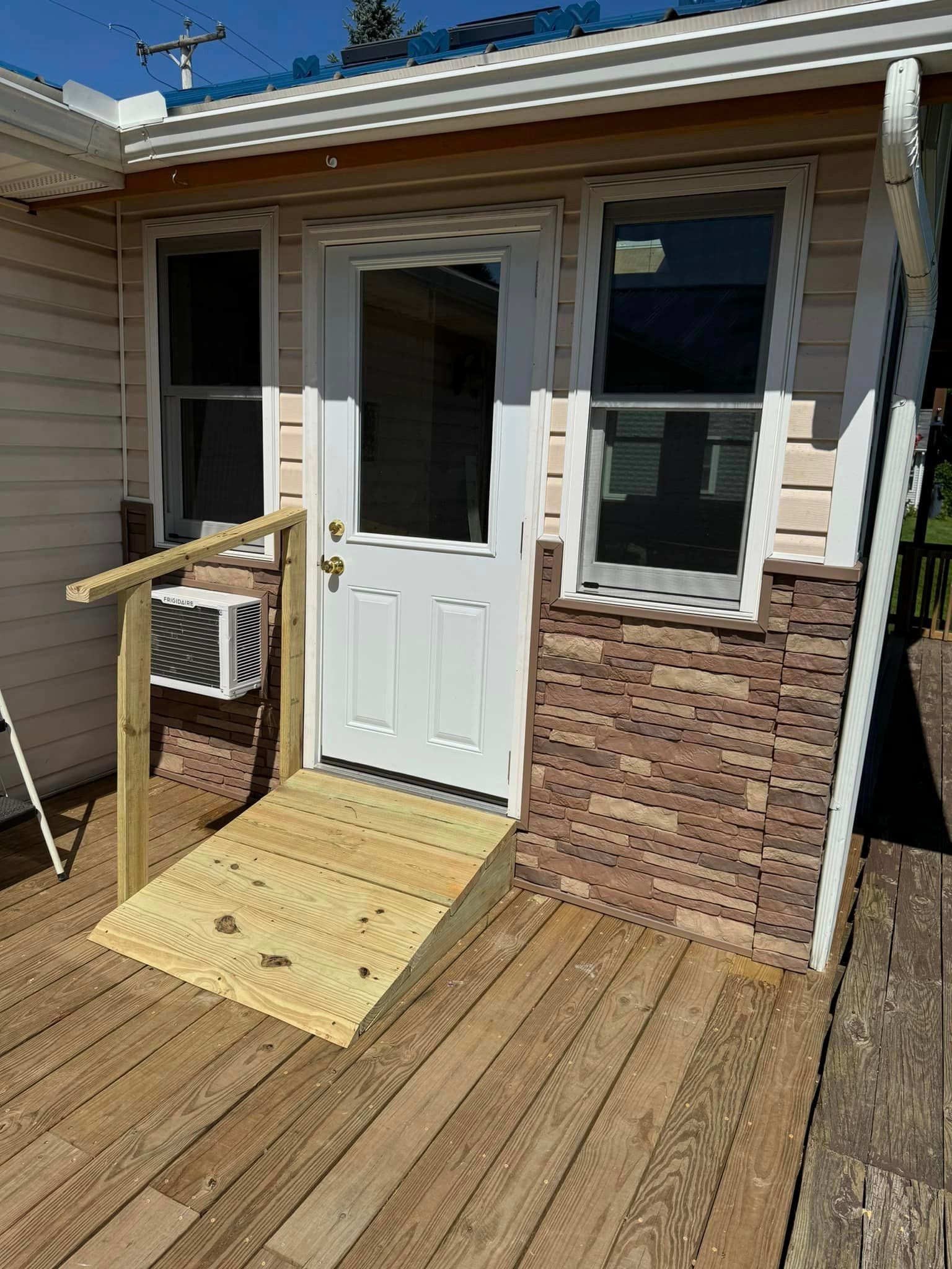 A house with a wooden ramp leading to the front door.