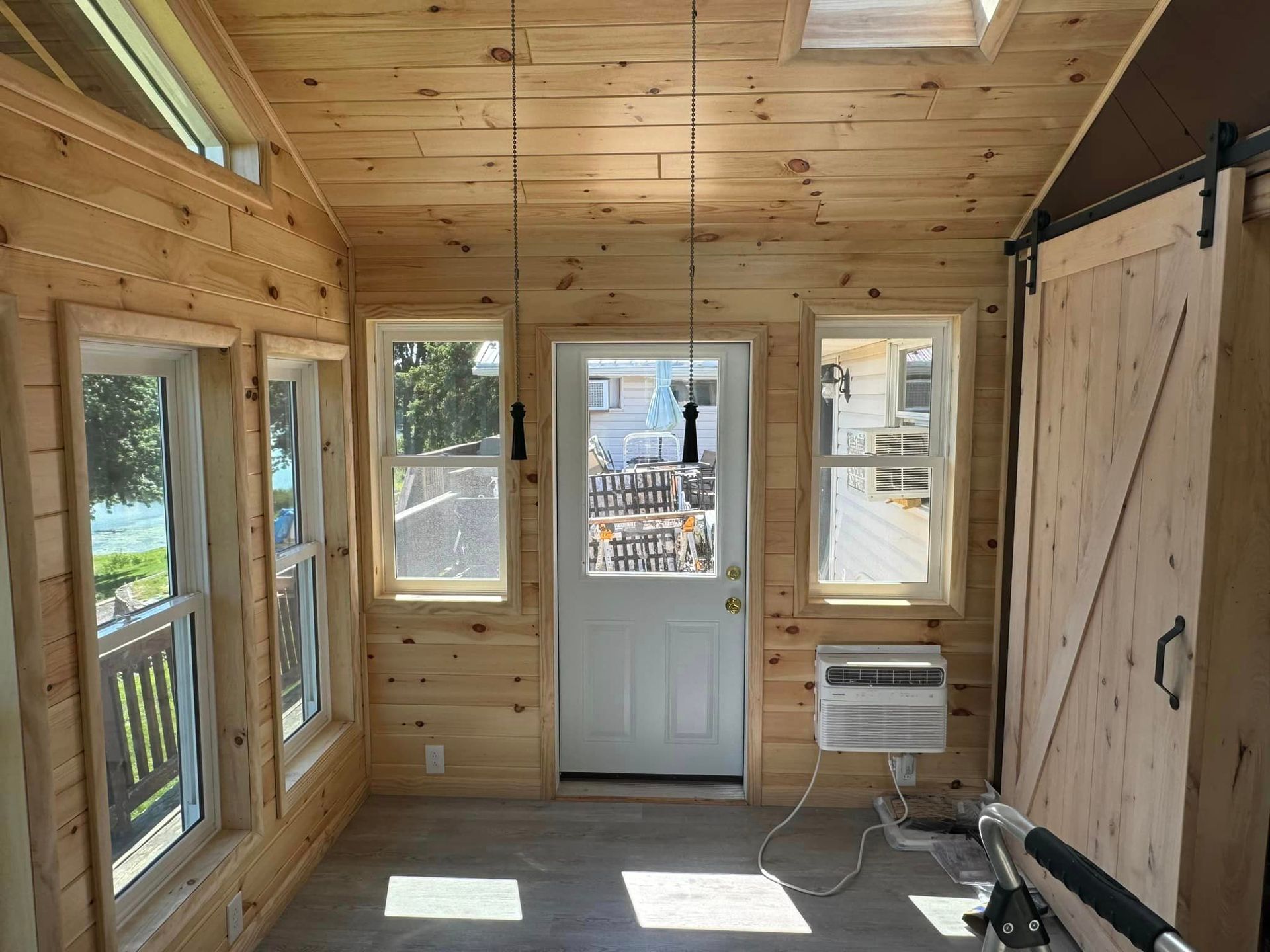 A room with a lot of windows and a door