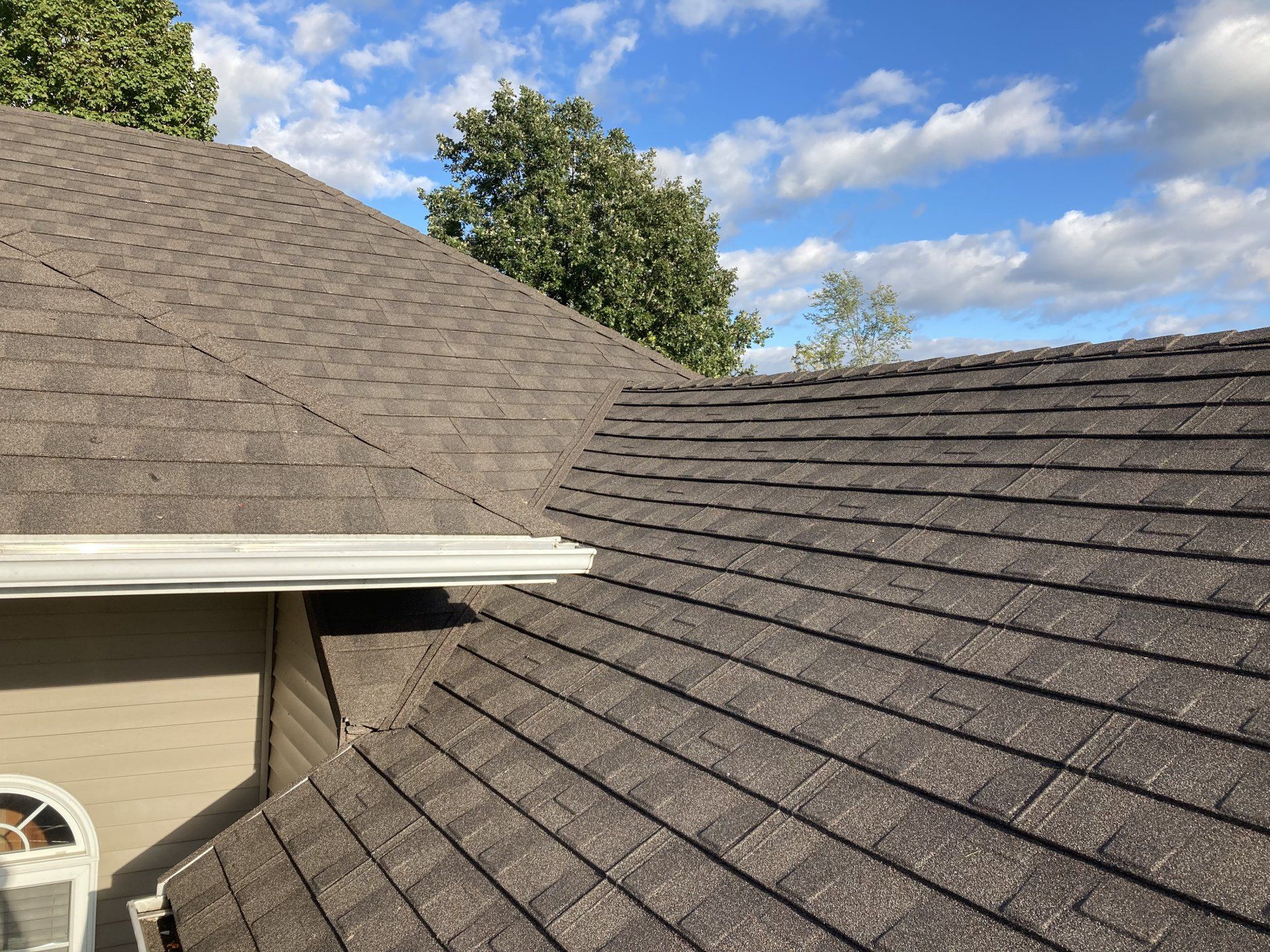 A close up of a roof with a blue sky in the background.