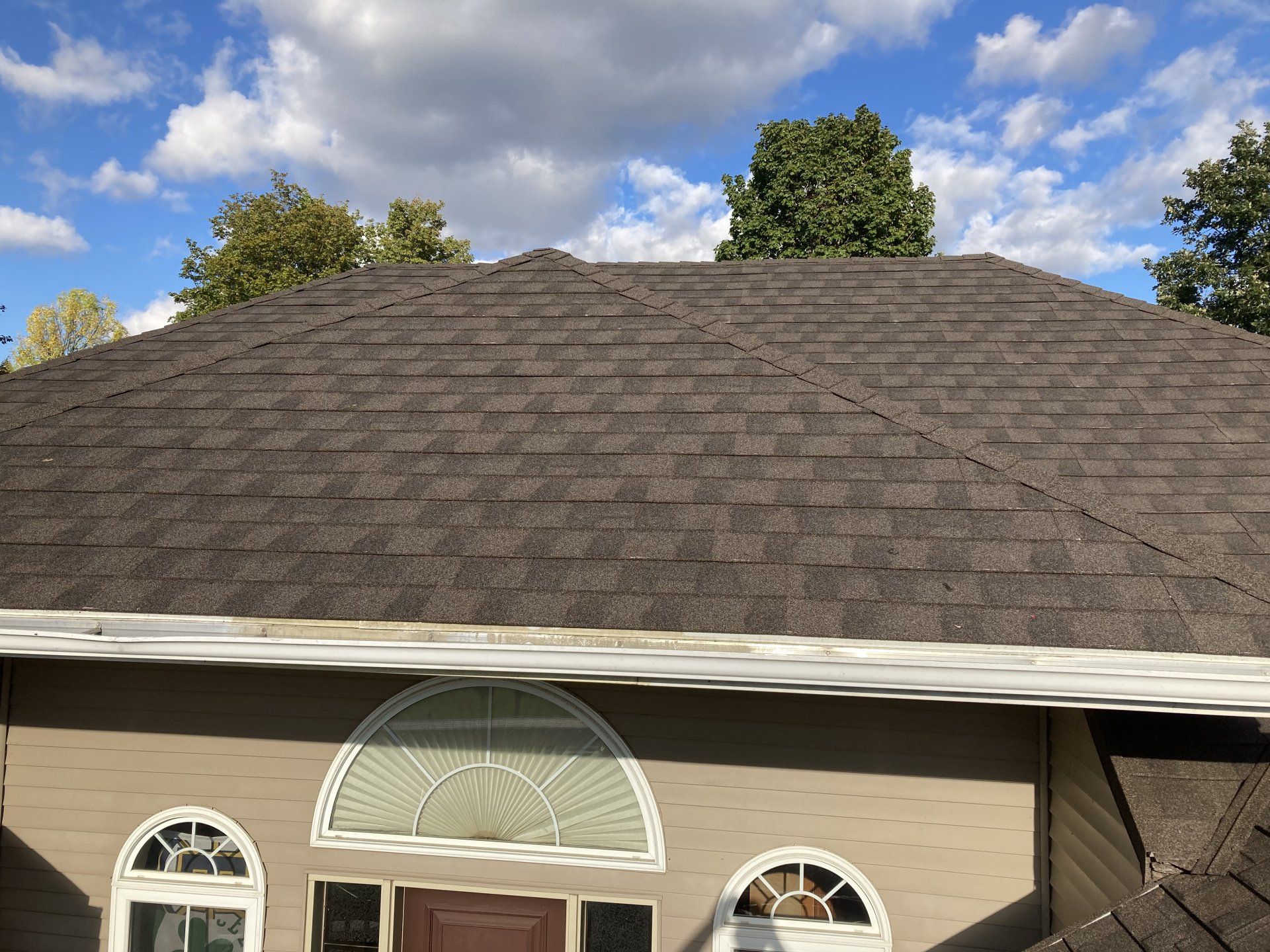 A house with a roof that has shingles on it.