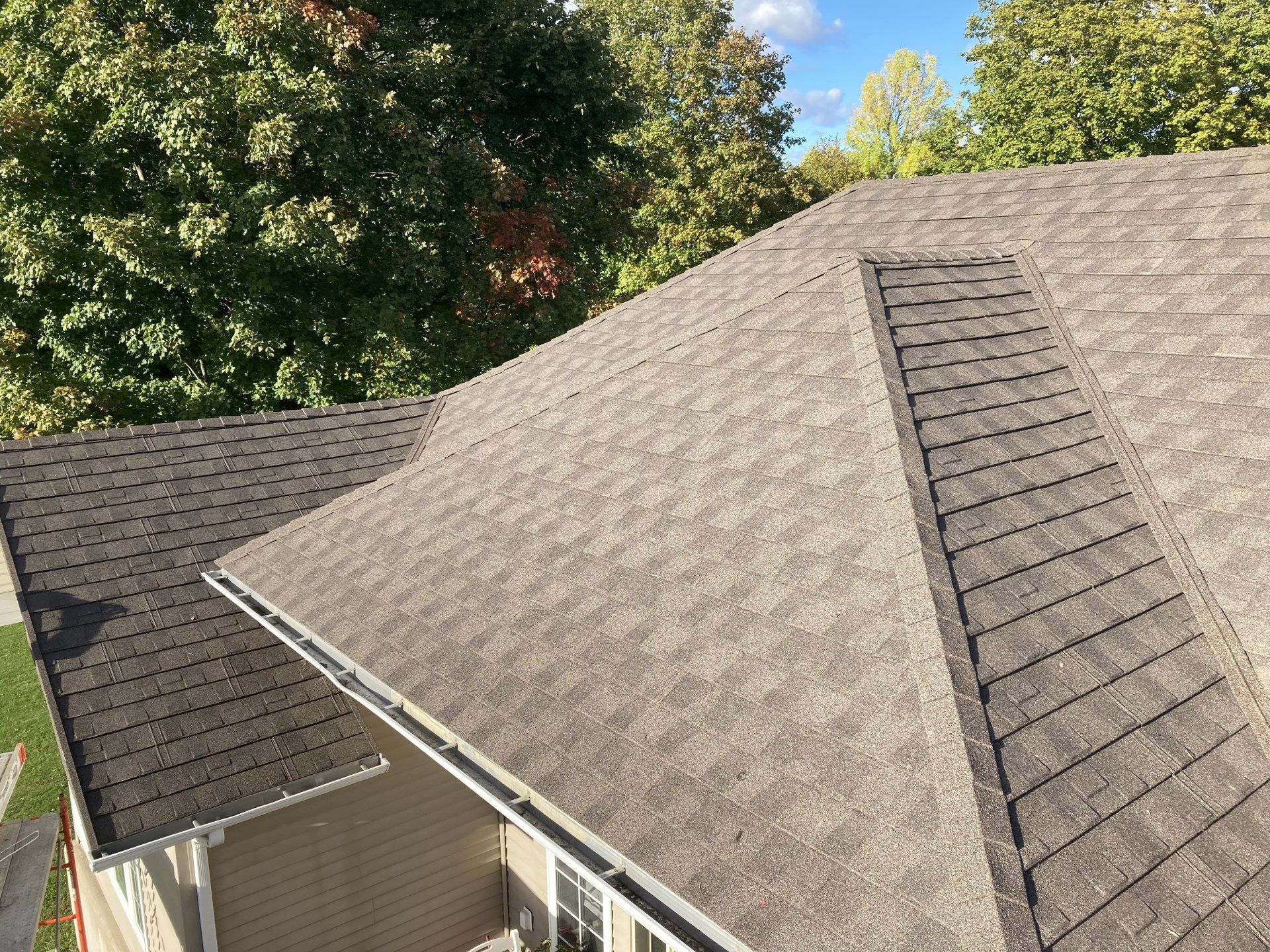 An aerial view of a house with a new roof.